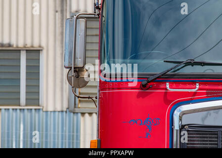 Partial view from in front of an Australian red and blue painted Kenworth semi trailer, prime mover heavy truck Stock Photo