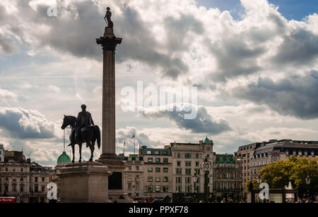 London / UK - September 15, 2018: The statue of King George IV and the Nelson column in Trafalgar Square, on a cloudy afternoon, in the fall.