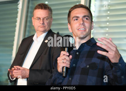 28 September 2018, Hessen, Frankfurt Main: Philipp Lahm (r), ambassador of the DFB for the EM application, speaks for the staff and the delegation at a reception at the DFB headquarters alongside Reinhard Grindel, President of the German Football Association (DFB). The day before, the Uefa had awarded the 2024 European Soccer Championship to Germany. Photo: Arne Dedert/dpa Stock Photo