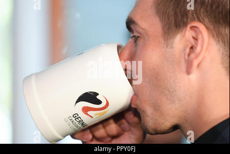 28 September 2018, Hessen, Frankfurt Main: Philipp Lahm, ambassador of the DFB for the European Championship application, drinks from a beer mug at the headquarters of the German Football Association (DFB) at a reception for the employees and the delegation. The day before, the Uefa had awarded the 2024 European Soccer Championship to Germany. Photo: Arne Dedert/dpa Stock Photo