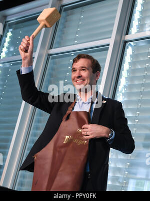 28 September 2018, Hessen, Frankfurt Main: Friedrich Curtius, Secretary General of the German Football Association (DFB), holds up the bat at a reception for the employees and the delegation at DFB headquarters after a barrel tapping. The day before, the Uefa had awarded the 2024 European Soccer Championship to Germany. Photo: Arne Dedert/dpa Stock Photo