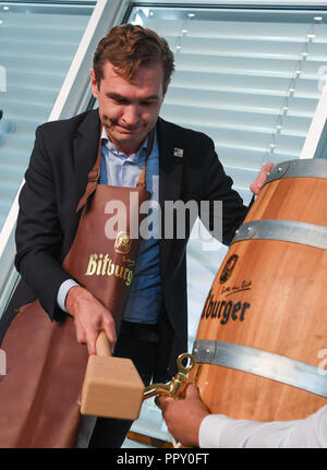 28 September 2018, Hessen, Frankfurt Main: Friedrich Curtius, Secretary General of the German Football Association (DFB), tapped a beer barrel at a reception for employees and the delegation at DFB headquarters. The day before, the Uefa had awarded the 2024 European Soccer Championship to Germany. Photo: Arne Dedert/dpa Stock Photo