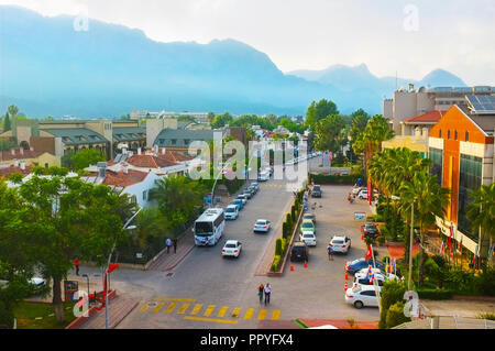 KEMER, TURKEY - MAY 13, 2017: The morning in resort, the bright sun shines behind the foggy mountains, the streets are empty and quiet, on May 13 in K Stock Photo