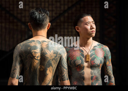 A women stands for a photo during the International tattoo convention at  Tobacco Dock in east London Stock Photo - Alamy