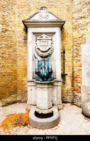 Statue of swan as water drinking fountain in the historic center - Bruges, Belgium Stock Photo