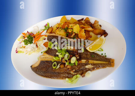 Fish dish-fried fish Plaice fillet and vegetables with fried potatoes Stock Photo