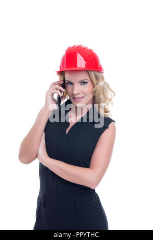 Young engineer woman in red helmet calling isolated on white Stock Photo