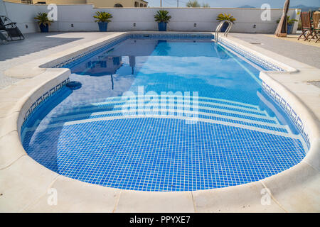 Swimming pool in Spain being het cleaned and retiled Stock Photo