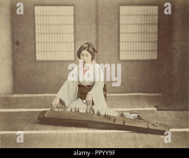 Japanese Woman Playing a Koto; Japan; 1890s; Hand-colored Albumen silver print Stock Photo