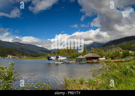 WHISTLER, BC, CANADA - JUNE 2018: Wide angle view of a Whistler Air De Havilland Turbine Otter aircraft tied at the jetty of the seaplane terminal in  Stock Photo