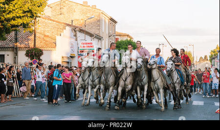 Saint Gilles,Camargue-France 2016 Traditional festival every year in August,the horsemen surround the bull with the horses running through the streets Stock Photo