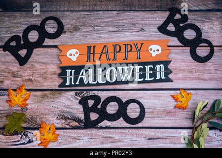 Happy Halloween boo Halloween background on wood backdrop with pumpkins and maple leaves. Fall and Halloween concept Stock Photo