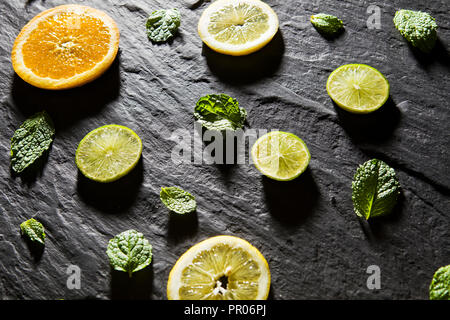 Lime background. Limes with leaves and ice. On the stone table. Free space for text . Top view Stock Photo