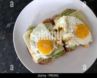 Egg Cheese and Avocado Toasts can also be seen as the vegetarian version of Dutch Uitsmijters. Stock Photo
