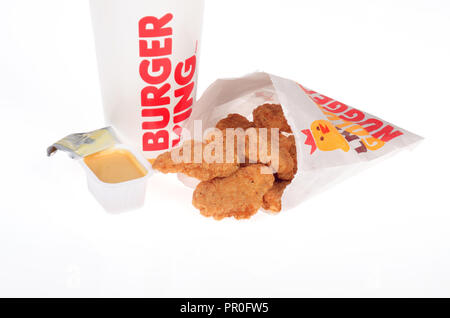Burger King chicken nuggets with honey mustard dipping sauce and a drink cup Stock Photo