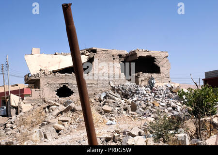 Destroyed (right) and rebuilt residential building in Bashiqua, northern Iraq, Kurdistan Stock Photo