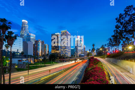 Downtown financial district of Los Angeles city and busy freeway at night, Los Angeles, California, United States of America, North America Stock Photo