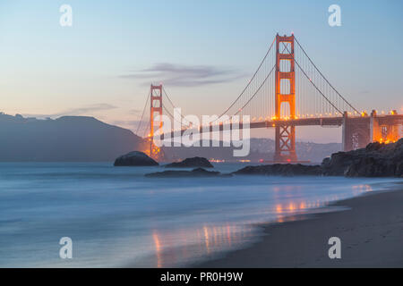 View of Golden Gate Bridge from Baker Beach at dusk, South Bay, San Francisco, California, United States of America, North America Stock Photo