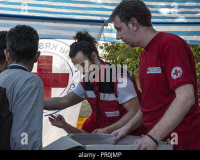 BERKASOVO, SERBIA - OCTOBER 3, 2015: Workers of the Red Cross of Serbia (Crveni Krst Srbije) providing aid at the border between Serbia and Croatia du Stock Photo