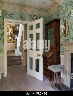 Antique cabinet behind doorway in split level London home Stock Photo