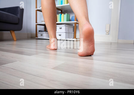 Close Up Of A Woman S Foot Walking On Heated Hardwood Floor Stock