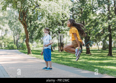 Cute happy children with jumping ropes on white background, collage ...