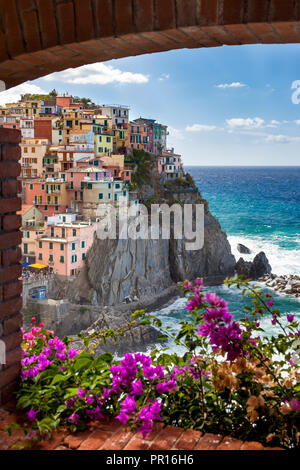 Swirling ocean at the foot of medieval town of Manarola in The Cinque Terre, Liguria Italy Stock Photo