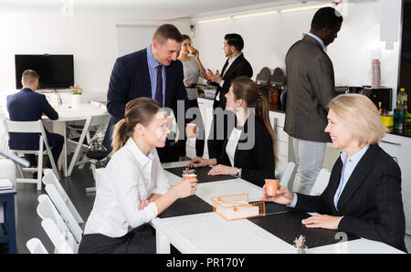 multinational business people team having break at office, drinking coffee and talking Stock Photo