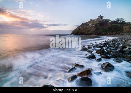 Criccieth Castle, above Criccieth Beach at sunrise, Gwynedd, North Wales, United Kingdom, Europe Stock Photo