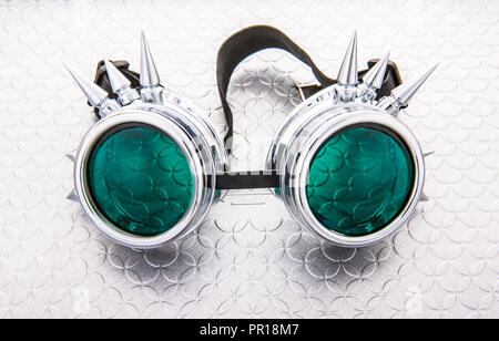 Pair of Steam Punk goggles on a silver background Stock Photo