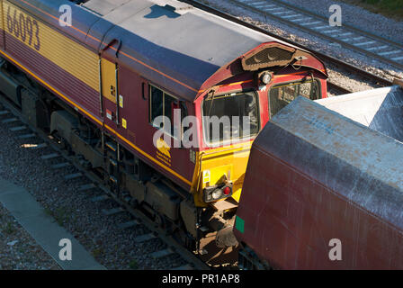 Class 66 No 66093 at Peak Forest reversing a long train of stone hoppers into the Cemex loading area. Stock Photo