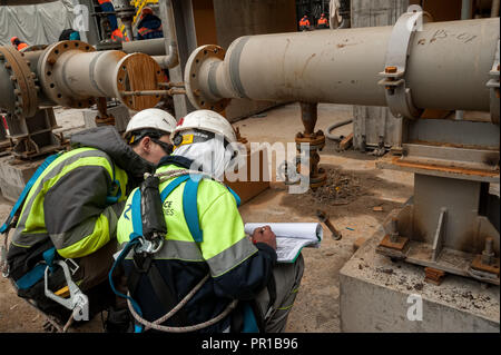 Worker on construction site checking documents Stock Photo