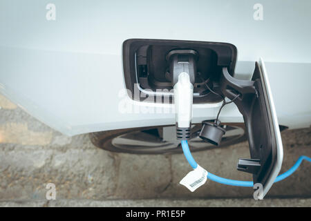 Electric car charging at charging station Stock Photo