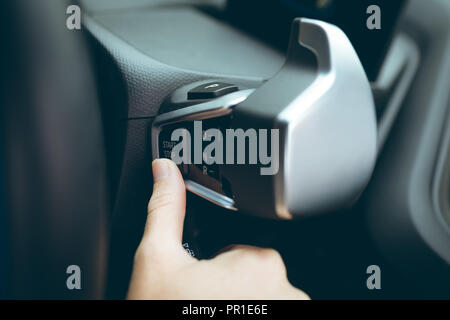 Businesswoman pushing the start stop button Stock Photo