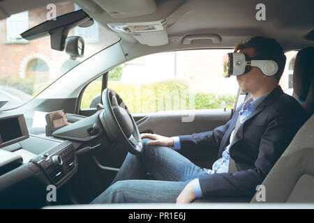 Businessman using virtual reality headset Stock Photo