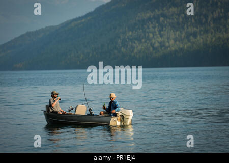 Two fishermen having beer while fishing in the river Stock Photo