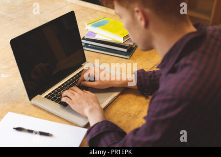 College student using laptop in library Stock Photo