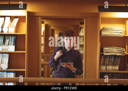 College student with digital tablet looking at camera Stock Photo