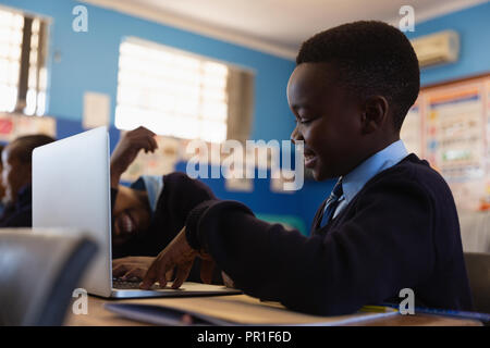 Student using laptop in the classroom Stock Photo