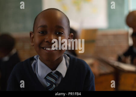Schoolboy standing in the classroom Stock Photo