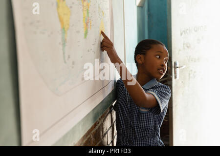 Schoolboy explaining about world map in classroom Stock Photo