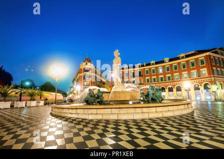 Famous Fountain du Soleil. Main square of Place Massena in Nice at night. French Riviera, France Stock Photo