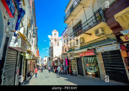 Shopping street in medina with view of mosque at old town Tangier. Morocco, North Africa Stock Photo