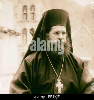 Greek Orthodox priest at St. Catherine's Monastery in the Sinai holding prized manuscript with silver cover from the library Stock Photo