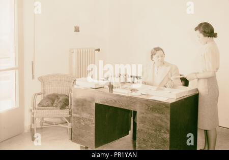 British Red Cross & St. John. Miss Riddler at her desk. 1941, Jerusalem, Israel Stock Photo