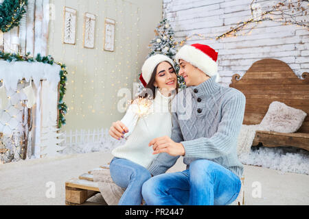 Happy young couple  having fun at Christmas. Stock Photo