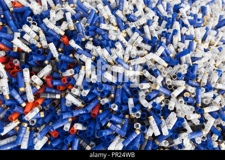 Shotgun shells. Background of many colorful shot empty shotgun shells, blue, red, yellow, purple colored Stock Photo