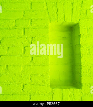 Modern vintage lime green stone brick wall texture background with empty window frame work Stock Photo