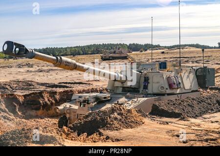 An M109A6 Paladin assigned to 1st Battalion 82 Field Artillery regiment, 1st Armored Brigade Combat Team, 1st Cavalry division prepares for a fire mission while conducting joint training with their Polish counterparts 23rd FA. The training was in support of Atlantic resolve Stock Photo