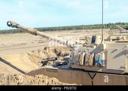 An M109A6 Paladin assigned to 1st Battalion 82 Field Artillery regiment, 1st Armored Brigade Combat Team, 1st Cavalry division prepares for a fire mission while conducting joint training with their Polish counterparts 23rd FA. The training was in support of Atlantic resolve Stock Photo